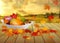 Fruits and autumn leaves on a plate on wooden table