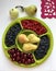 Fruits and berries lie in containers on a round tray.