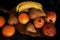 Fruits on black background. Pomegranates, oranges, pears, bananas basket