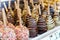 Fruits covered with chocolate and various glazes for sale in a m