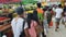 Fruits Displayed for Sale as People Line Up for Jeepney