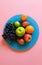 Fruits Grape Citrus pear mandarin Lime Green orange grape on Blue plate Pink and white Background concept Sweet fruits Still lif