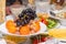 Fruits-grapes, oranges, tangerines, lemon on holiday table