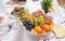 Fruits - Grapes, pears, persimmons, tangerines. Against the background of the table with appetizers