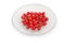 Fruits of hawthorn on glass saucer on a white background