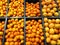 Fruits mandarins and grapefruits lying in boxes in supermarket