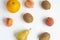 Fruits pears, kiwis, peaches and orange on a white background