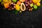 Fruits. Seasonal and tropical fruits on a black stone background. Food background. Top view.