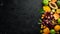 Fruits. Seasonal and tropical fruits on a black stone background. Food background. Top view.