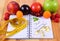 Fruits, tablets supplements and centimeter with notebook, slimming and healthy food