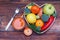 Fruits and Vegetables in Heart shaped Wooden Box. Broccoli, apples, Pepper, tangerine and glass of juice over Wooden Background. B