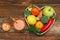 Fruits and Vegetables in Heart shaped Wooden Box. Broccoli, apples, Pepper, tangerine and glass of juice over Wooden Background. B