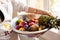 Fruits and vegetables in a large wash bowl. The pastry chef collects the fruit