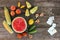 Fruits, vegetables, pills on wooden background.