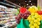 Fruits and vegetables in shopping bag with supermarket grocery store blurred defocused background