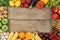 Fruits and vegetables on wooden board with copyspace