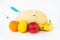 Fruits on a white background bananas, orange, melon, lemon and nectarine in which gmo and nitrates are injected from the syringe