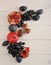 Fruits on white wooden background - pomegranate, plums, apples,