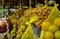 fruits wrapped with net are hung in fruit shop