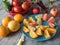 Fruity background with a group of oranges lemons, limes, mandarin and grapefruit, tomato, apple as a symbol of healthy eating and