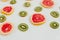 Fruity pattern of kiwi and grapefruit slices on the white background. Minimal colourful trend style