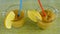 Fruity smoothies with lemon in two glass pens with straws