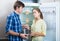 Frustraited starving female and man near fridge without any food