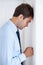 Frustrated businessman, stress and mistake in anger, anxiety or burnout with fist on wall at office. Upset man or