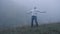 Frustrated depressed man in depression screams with anger standing alone in the fog,slow mo