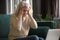 Frustrated elderly woman confused by laptop breakdown problems