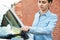 Frustrated Female Motorist Looking At Parking Ticket