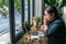 Frustrated freelancer sitting with laptop, crumpled paper balls on table