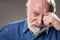 Frustrated hoary pensioner shedding tears