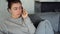Frustrated ill lady talking on phone at home