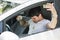 Frustrated Man in Car with Spilled Coffee on Shirt