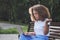 Frustrated mixed race lady freelancer talking online video call with colleague use laptop on bench