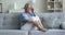 Frustrated older woman sits on sofa feeling disappointment