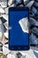 Frustrated phone on the rocks. Glass shattered on rocks on a sma