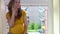 Frustrated pregnant woman call phone and shout sitting on window sill