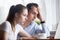 Frustrated surprised spouses looking at computer screen