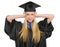 Frustrated woman in graduation gown closing ears