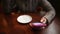 A frustrated young impatient girl in glasses is bored in the cafe. Handled closeup of a tired woman waiting for a