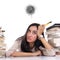 Frustrated young woman between stacks of books, white background