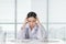 Frustration young female doctor sitting in her consulting room