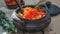 Fry in a frying pan sliced juicy orange pumpkin with wheat cereal and with country style spices in a clay pot. The concept of