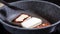 Fry halloumi cheese in a gray frying pan. Fried cheese in pan, close up.