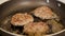 Frying beef cutlets in a pan