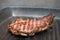 Frying beef steak on a grill pan