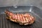 Frying beef steak on a ribbed grill pan