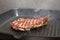 Frying beef steak on a ribbed grill pan